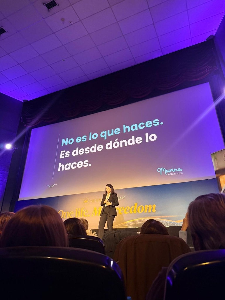 Marina Berenguer en el escenario del Summit'25 de MetaPro Academy, con la diapositiva «No es lo que haces. Es desde dónde lo haces.»